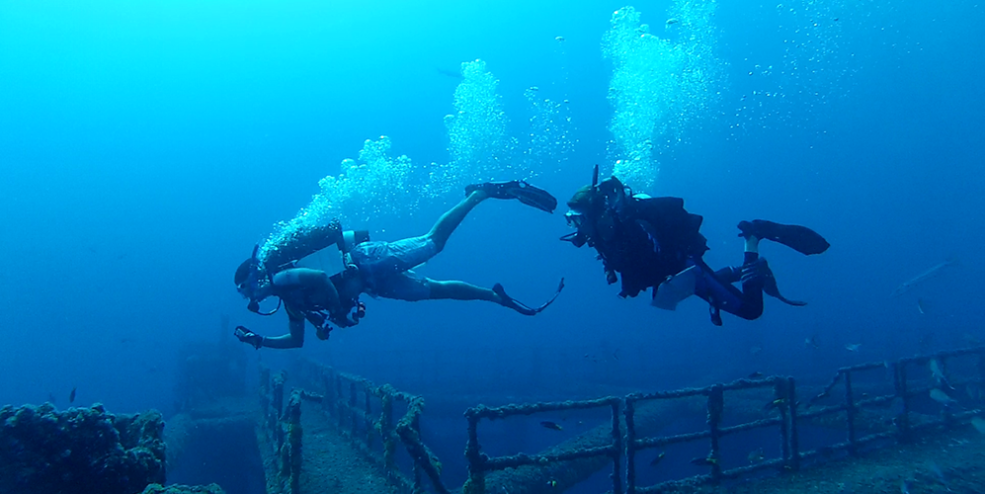 Two divers about to begin a fish survey on reef site MI-A-7, a cutoff platform. 